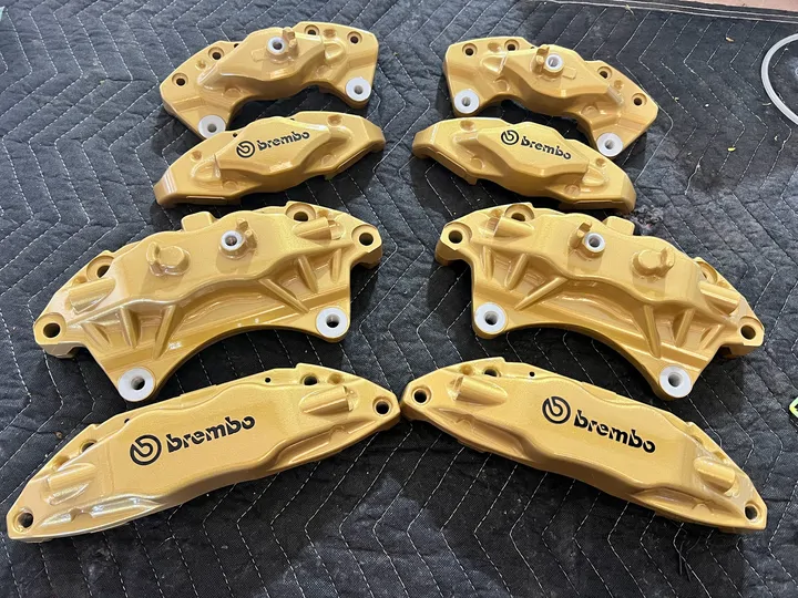 Tan Brembo calipers with black lettering
