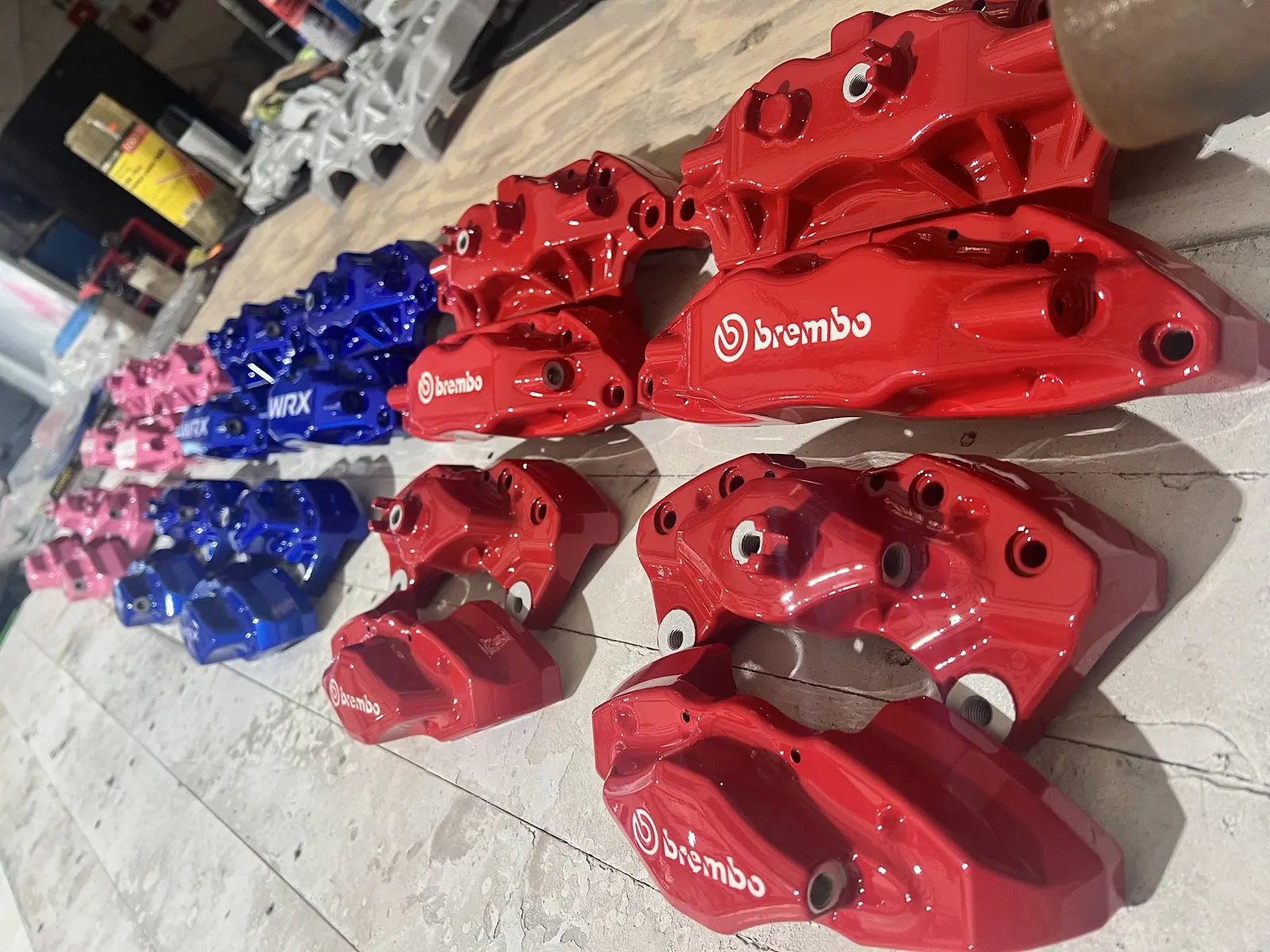 Red, blue and pink Brembo calipers