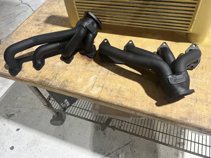 Pair of black exhaust manifolds