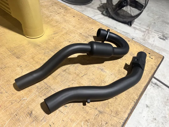 Pair of black coated pipes
