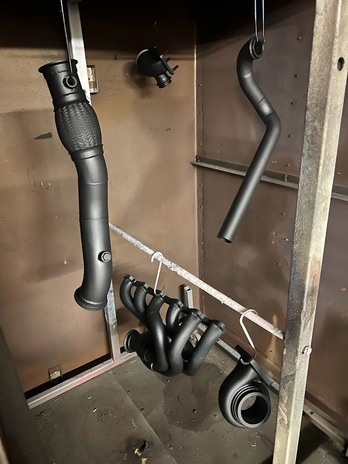 Coated exhaust parts hanging in the shop