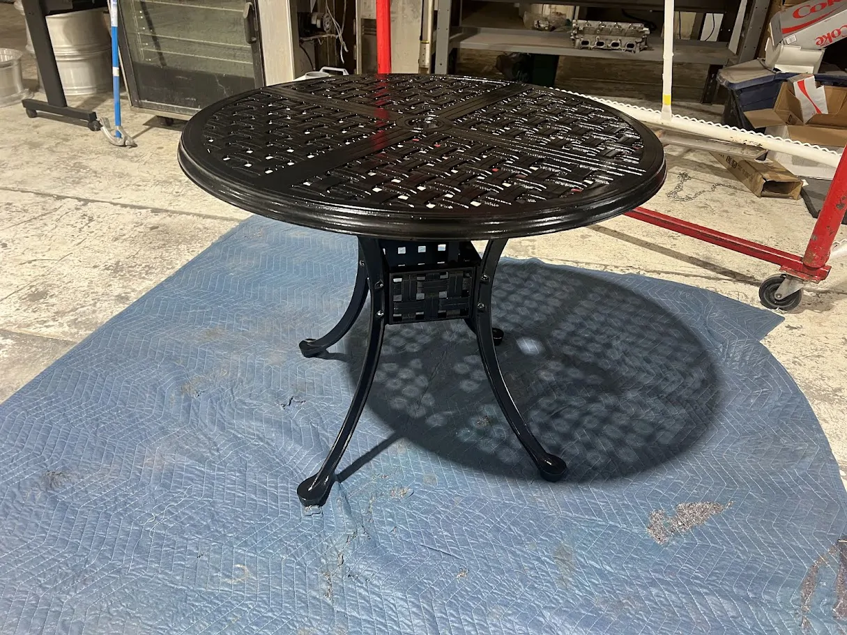 Black round patio table on the shop floor