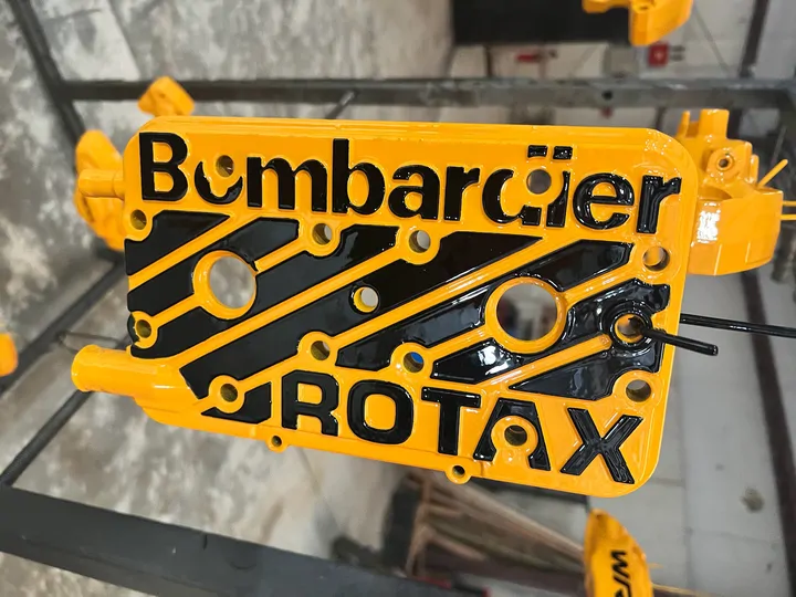 Yellow Bombardier Rotax cover with black lettering