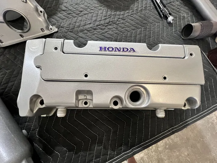 Silver Honda valve cover with purple lettering