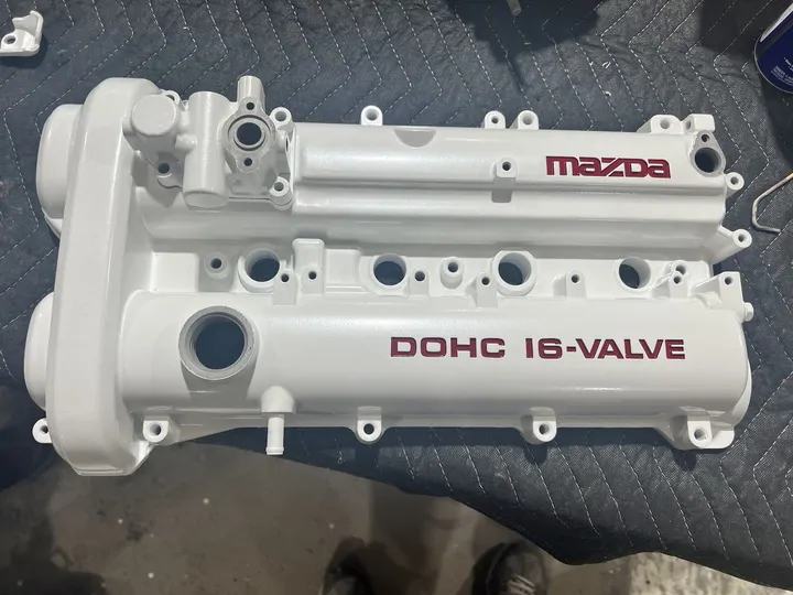 White Mazda DOHC 16-valve cover with red lettering