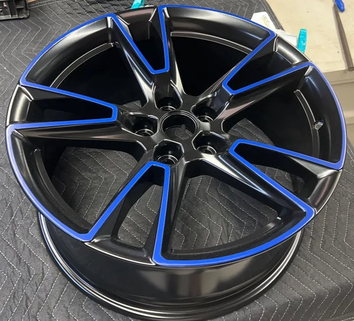 Black wheel with blue-outlined spokes