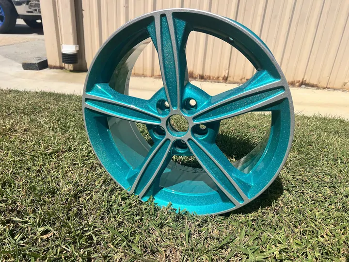 Teal metallic wheel with silver accents