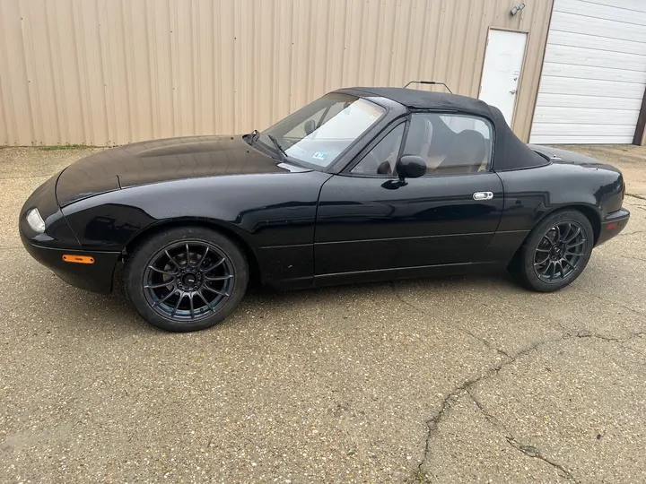 Black Mazda Miata on black wheels