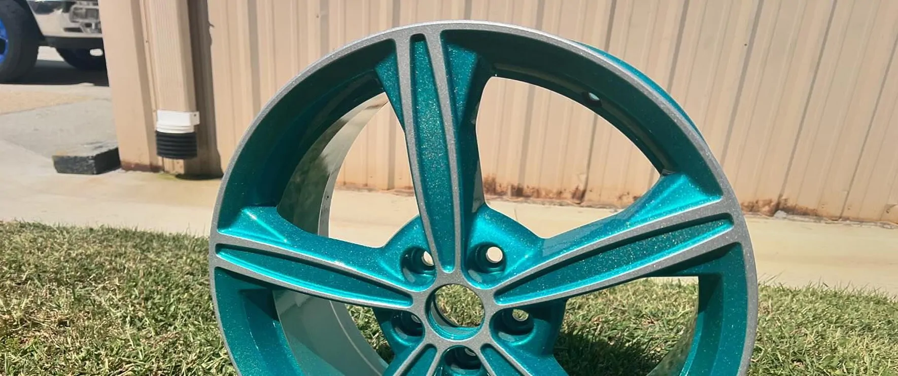 Teal metallic wheel after coating